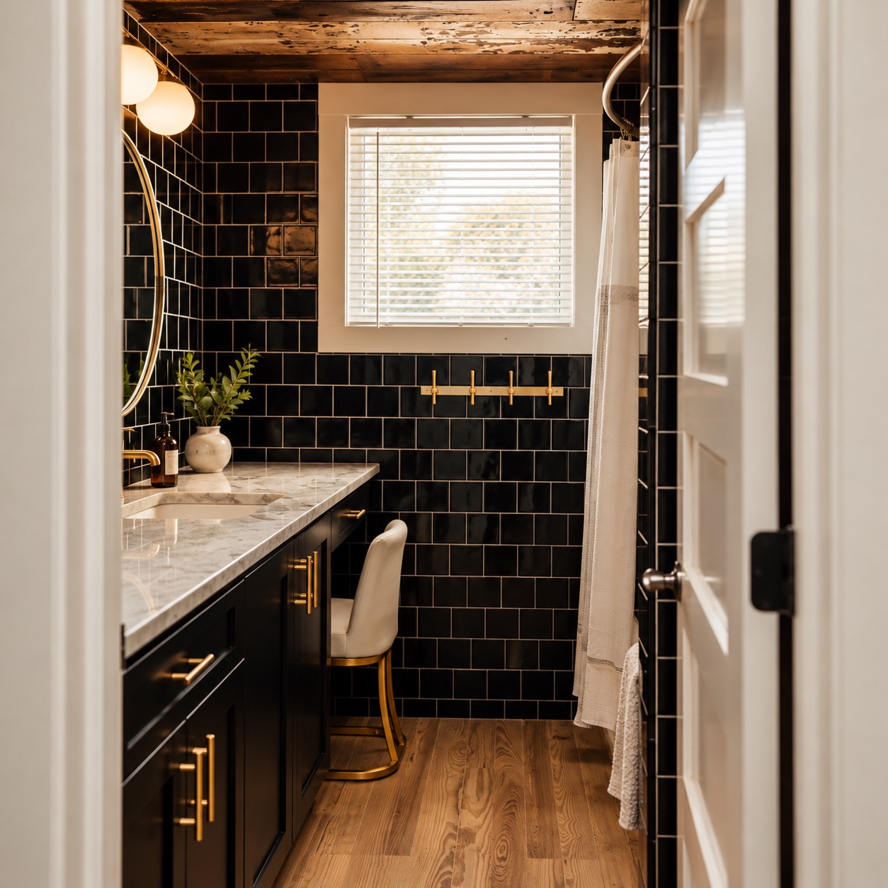 Renovated bathroom with black tile and brass fixtures