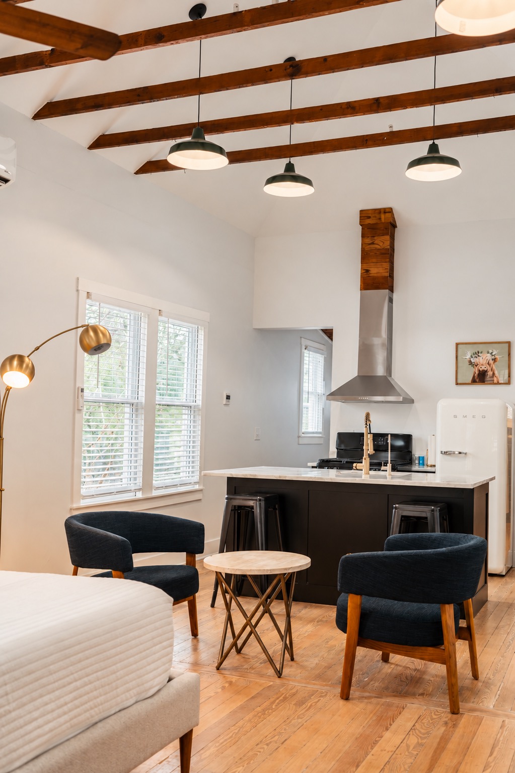 Open living space and kitchen with vaulted ceiling and exposed beams