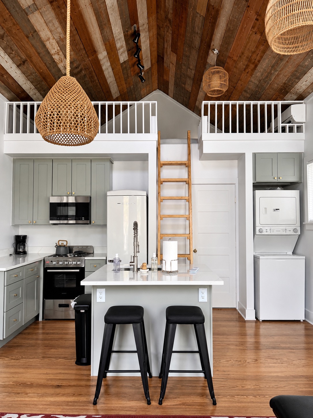 Renovated kitchen beneath two sleeping lofts with a ladder