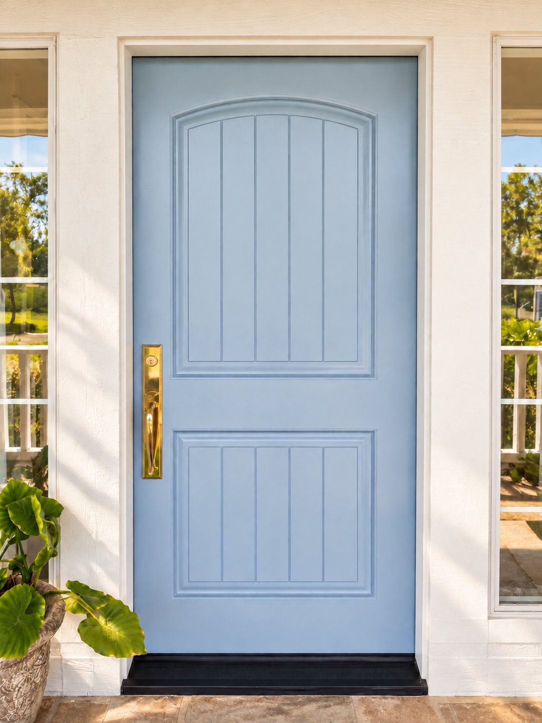Pale blue front door with brass handle and arched transom